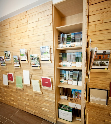 Plexwood® Savills HQ relief wall with storage cabinet in birch reverse glued plywood paneling