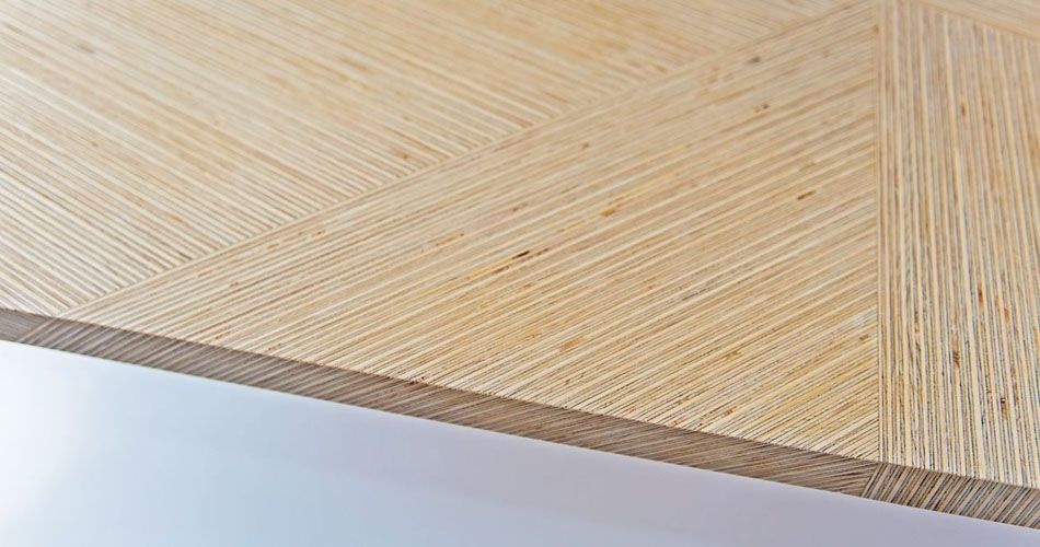 Plexwood® Deuvel design detail of a geometric patterned table with deal solid composed engineered veneer strips